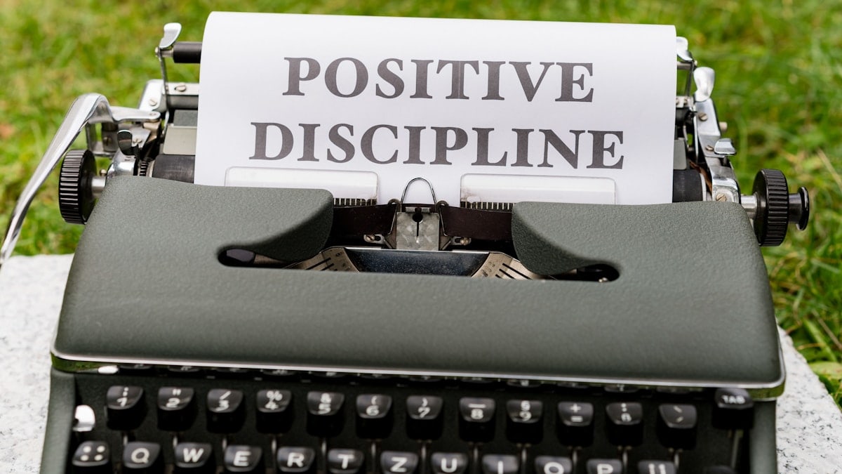 a close up of a typewriter with a paper that says positive, disc